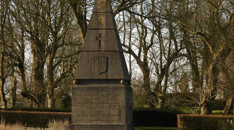 A historical monument surrounded by trees in a tranquil park during daylight.